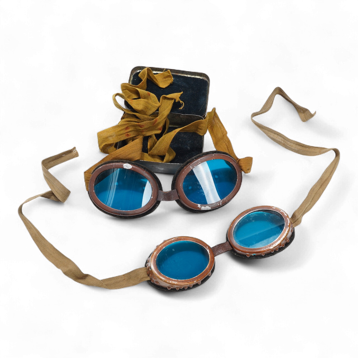 Two pairs of WW2 desert goggles, blue tinted lenses, one with original tin box